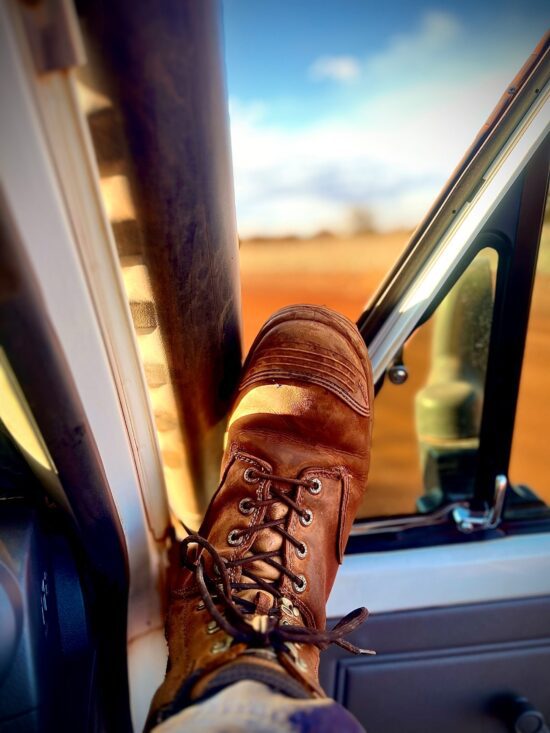 Photo for website - Foot on window Mining FIFO worker with his work boot on the edge of the car window in the Pilbara.